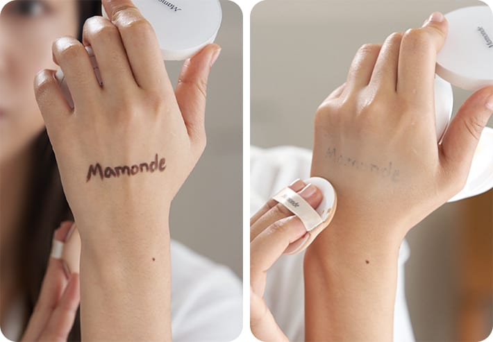 손등에 갈색으로 mamonde 라는 글씨를 쓰고, 브라이트닝 커버 파우더 쿠션을 사용하여 커버하는 연출컷